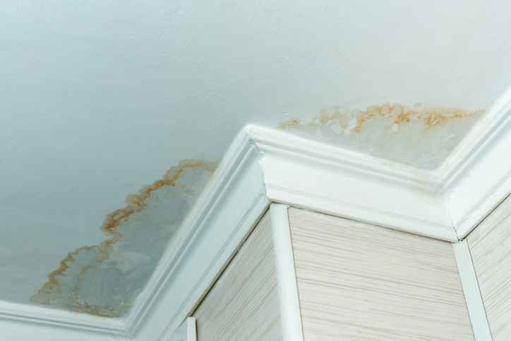 A close-up photo of a water leak on the ceiling